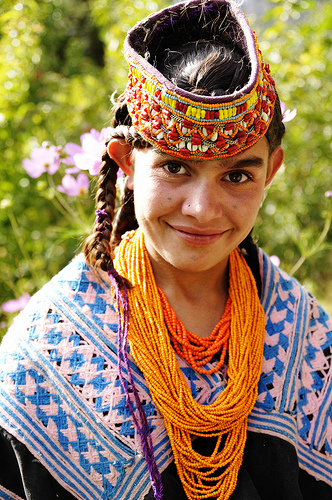 Kalasha girl with headdress and beaded necklace